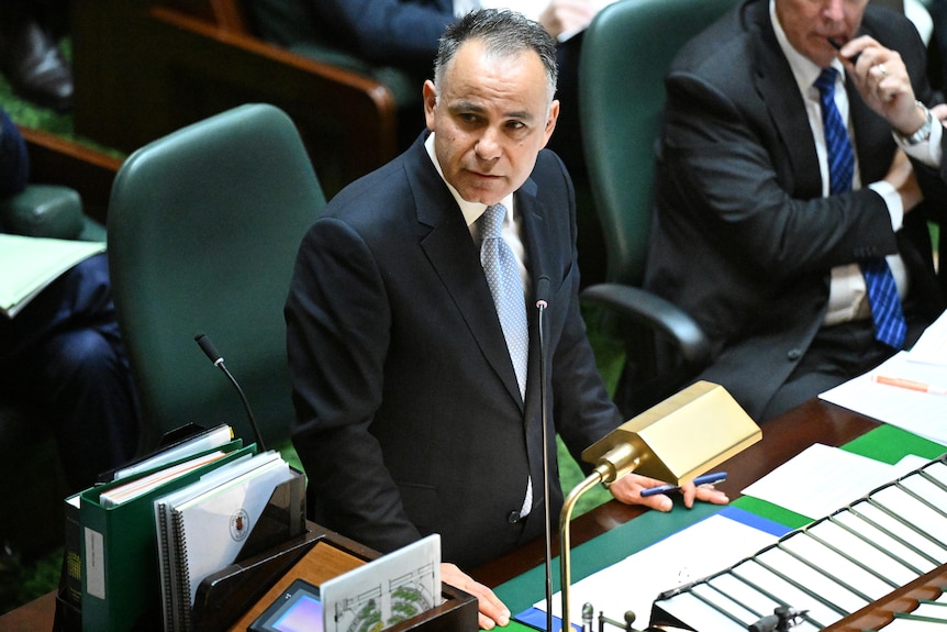 John Pesutto standing at a desk in Victoria's Parliament. 