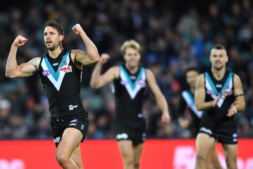 Travis Boak pumps his fists after kicking a goal for the Power against the Saints.