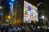 Images of messages and cards are projected on to the Lindt Cafe building.