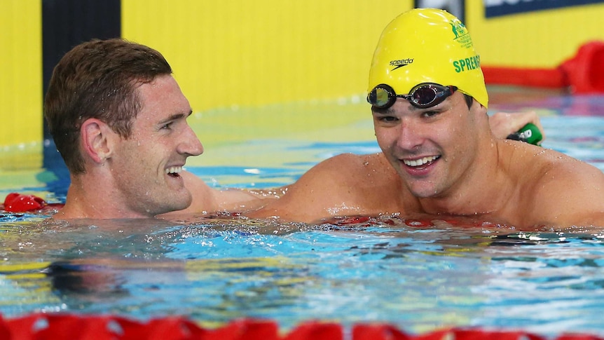 South Africa's Cameron van der Burgh (L) celebrates with Australia's Christian Sprenger (R) after the men's 50m breaststroke final