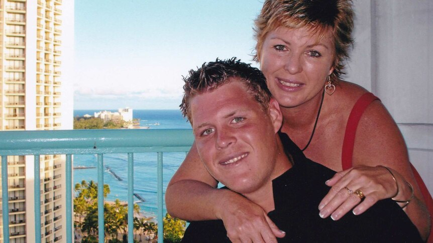 Mother and son pose for photo on a Gold Coast balcony.