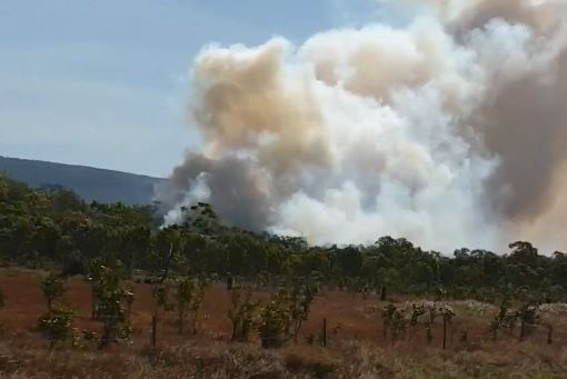 Smoke seen from a bushfire that has gutted one house in Cooktown, North Queensland.