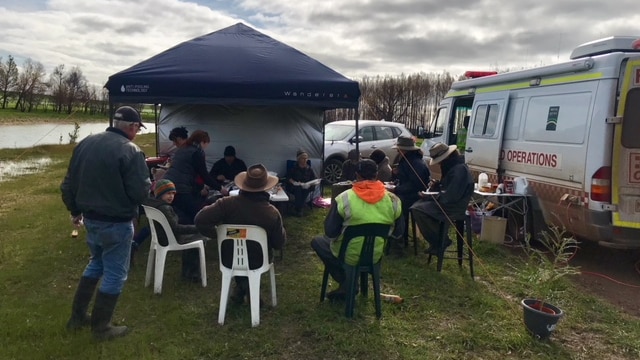 Bushfire victims from the St Patrick's Day fires gather for a sausage and a tea at a recovery van at Garvoc, in 2018