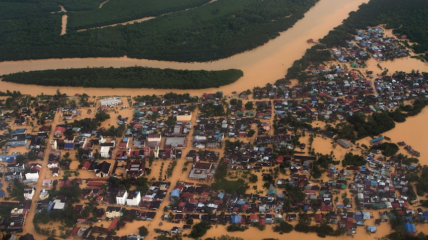 This aerial view shows houses and plantations submerged in floodwaters in Pengkalan Chepa, near Kota Bharu on December 27, 2014