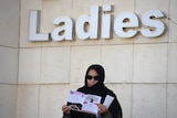Saudi candidate Amal Badreldin al-Sawari stands outside a polling station