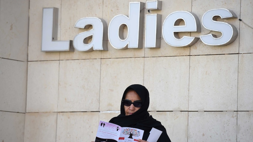 Saudi candidate Amal Badreldin al-Sawari stands outside a polling station