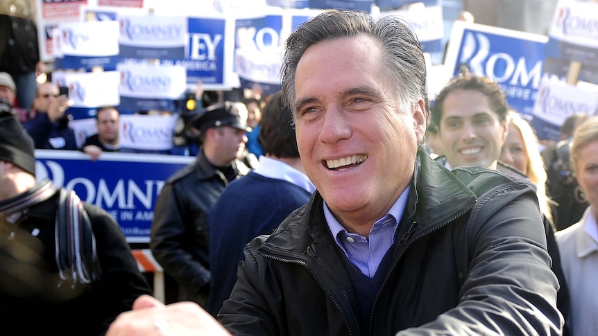 Mitt Romney greets voters outside a polling station in Manchester, New Hampshire