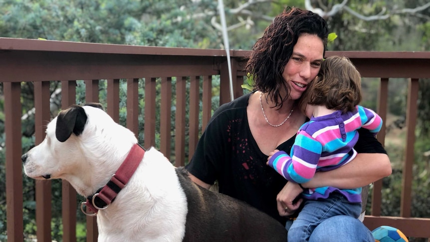 Jessica Wong with her dog and a young child.