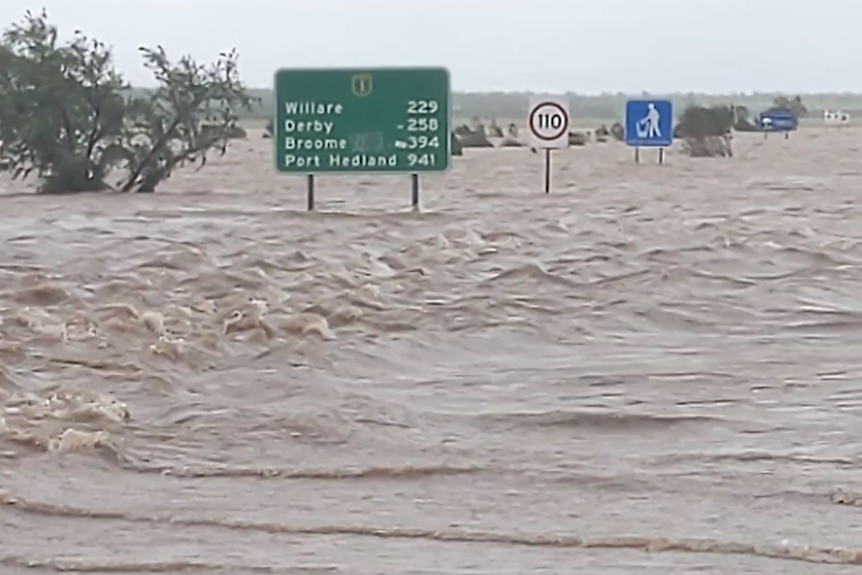 Huge amounts of water from the Fitzroy River stream across the Great Northern Highway.