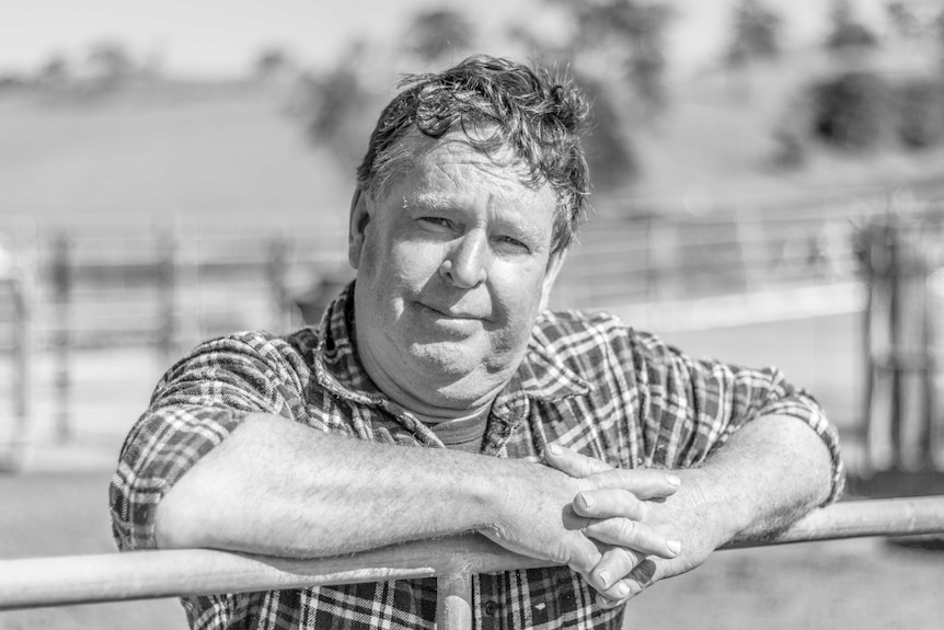 Ken Turnbull leans on a gate.