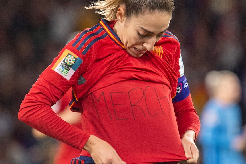 Olga Carmona lifts her jersey to reveal Merchi on her undershirt after a goal in the Women's World Cup final.