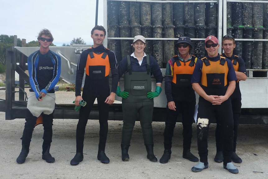 Neindorf and a group of men wearing waders and gumboots.