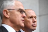 Prime Minister Malcolm Turnbull (foreground) with Peter Dutton (background) at a press conference in Canberra.