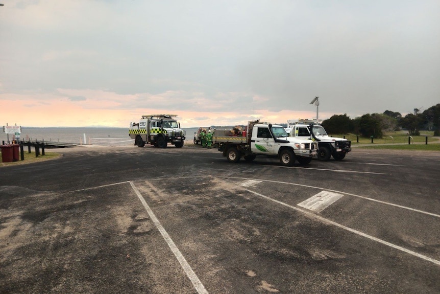 Fire fighting vehicles parked on a boat ramp.