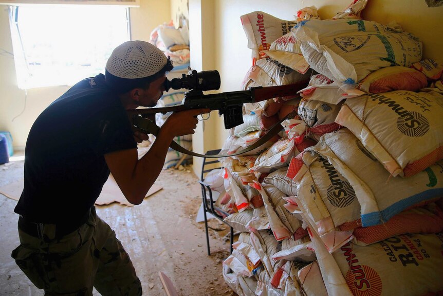 Free Syrian Army fighter takes aim in Damascus