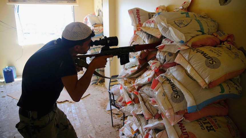 Free Syrian Army fighter takes aim in Damascus