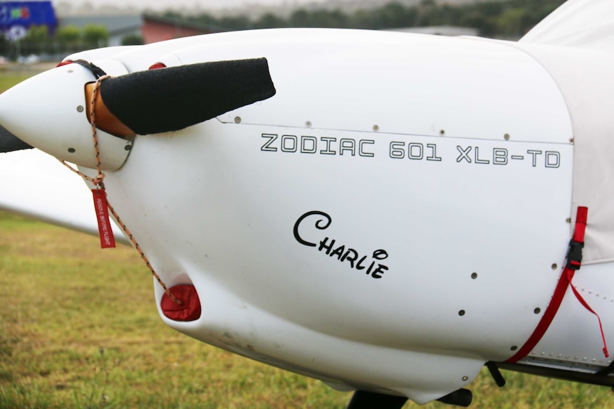 The nose of a plane, with a propeller, the name Charlie is written on it underneath the model details.