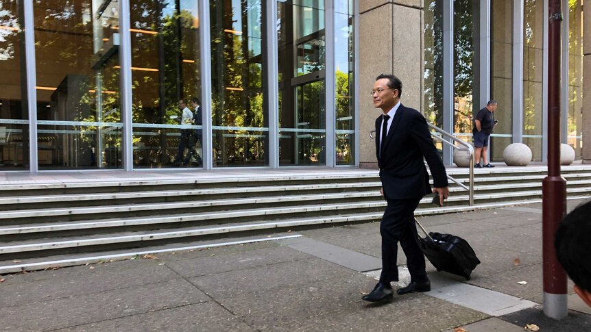 Eddie Kang walks in front of the Federal Court of Australia.