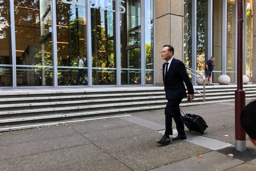 Eddie Kang walks in front of the Federal Court of Australia.