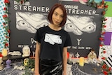 a woman in a gamer tshirt looking at the camera 