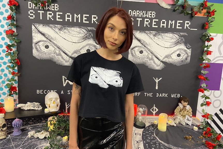 a woman in a gamer tshirt looking at the camera 