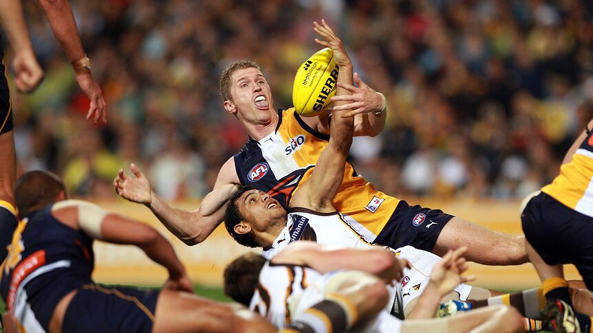 Sloppy affair ... Adam Selwood and Cyril Rioli battle for possession at Subiaco.