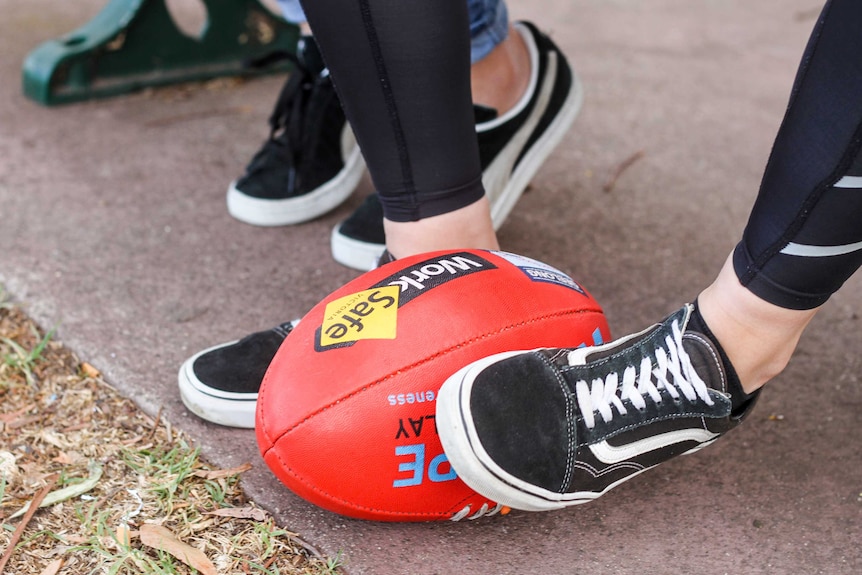 Children's feet and a football.