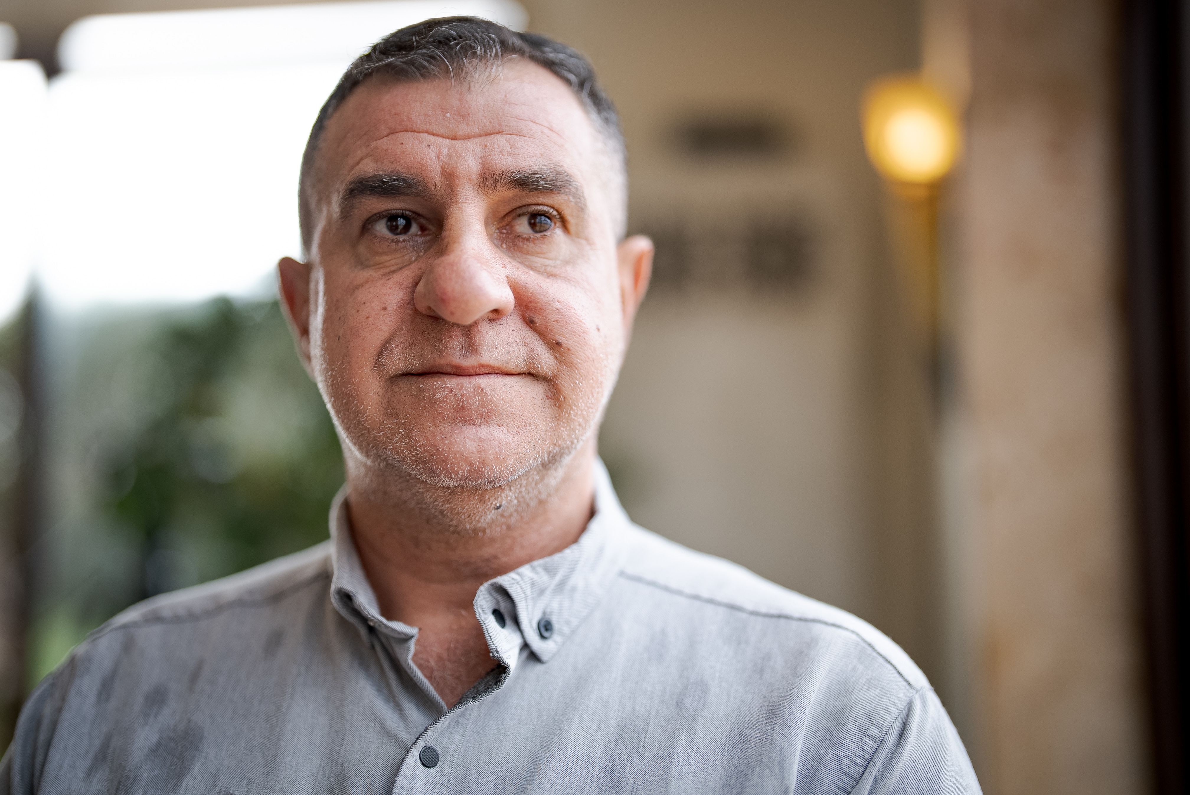 Man wearing a grey shirt.