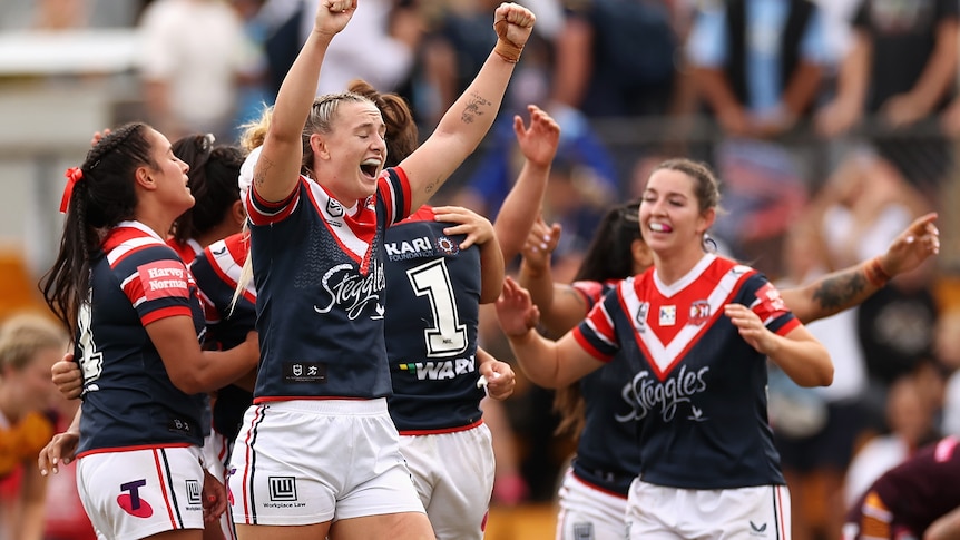 An NRLW side celebrate a victory 