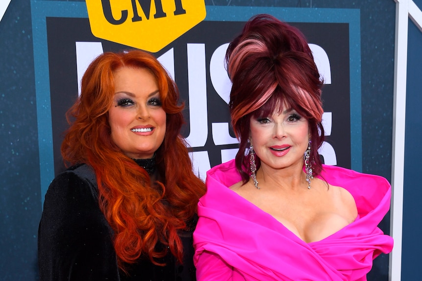 Wynonna Judd, left, and Naomi Judd pose for photos on red carpet.