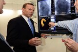 Tony Abbott listens to Dr David Muller explain some x-rays