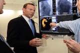 Tony Abbott listens to Dr David Muller explain some x-rays