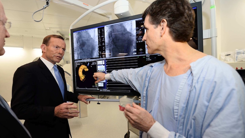 Tony Abbott listens to Dr David Muller explain some x-rays