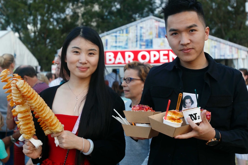 Julie Qi sampling many of the food fare at the markets.