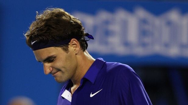 Roger Federer punches his fist at Australian Open