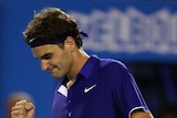 Roger Federer punches his fist at Australian Open