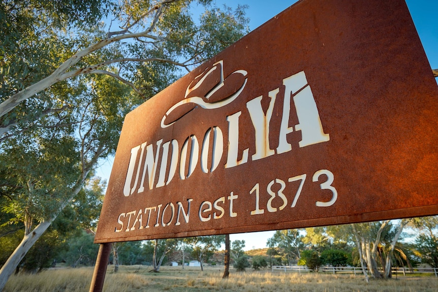 A rusted iron sign with the words Undoolya Station est 1873 on it. 