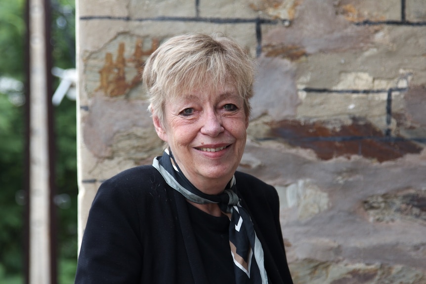 A woman smiles at the camera.