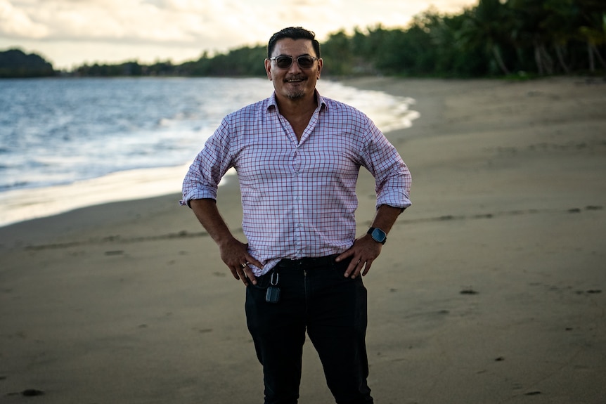 Image of a man standing in front of the beach.
