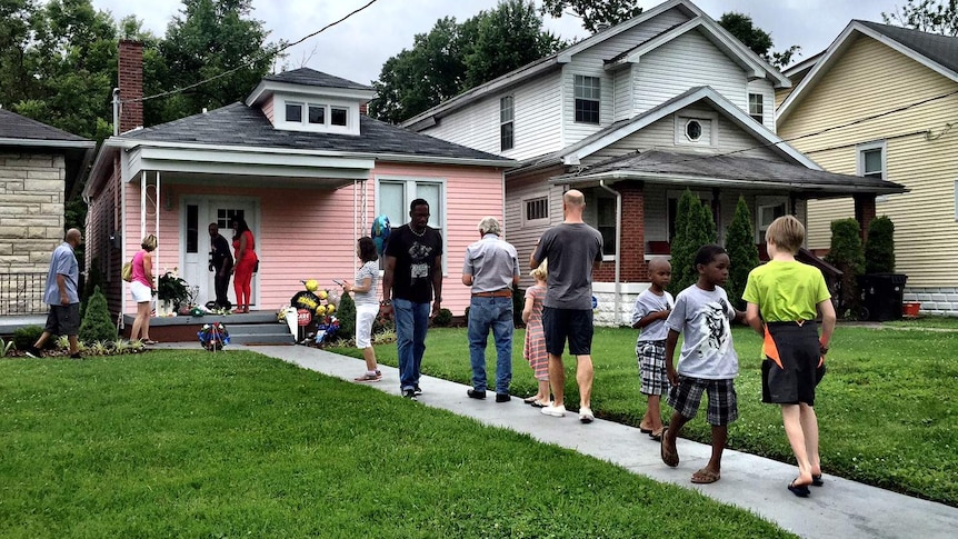 Mourners walk to and from Muhammad Ali's childhood home.