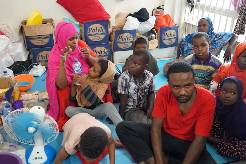 A woman from Somalia with her children and Sudanese man Ahmed Sudani in the Jakarta Immigration Detention Centre.