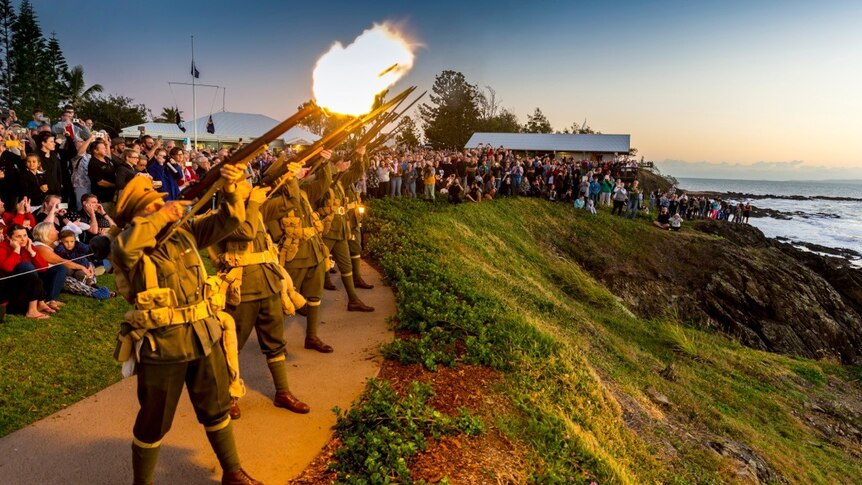 Men dressed in World War One uniforms fire shots at the dawn service at Emu Park