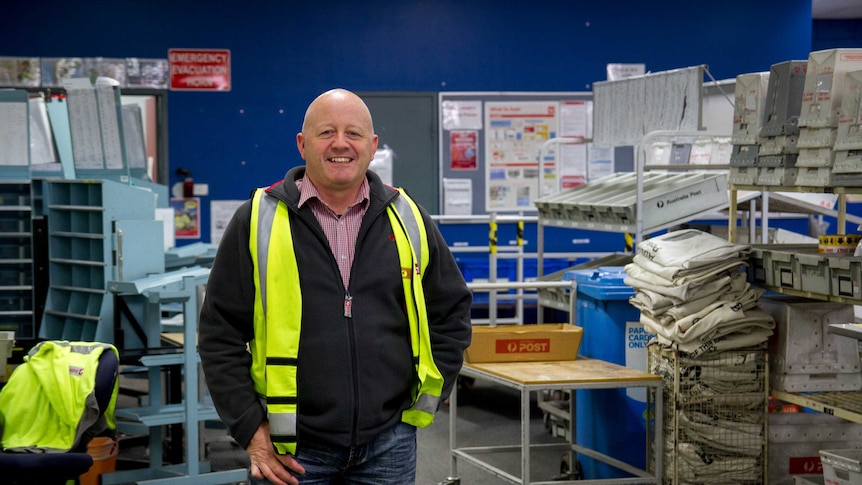 Australia Post Kalgoorlie delivery centre manager John Blake, standing in the middle of the depot.
