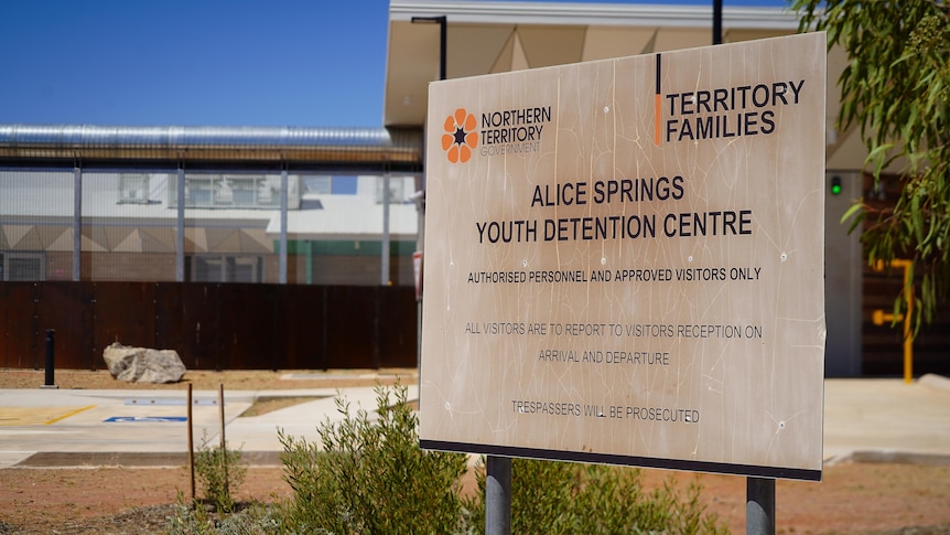 A sign that reads "Alice Springs Youth Detention Centre" in front of the entrance to the prison.