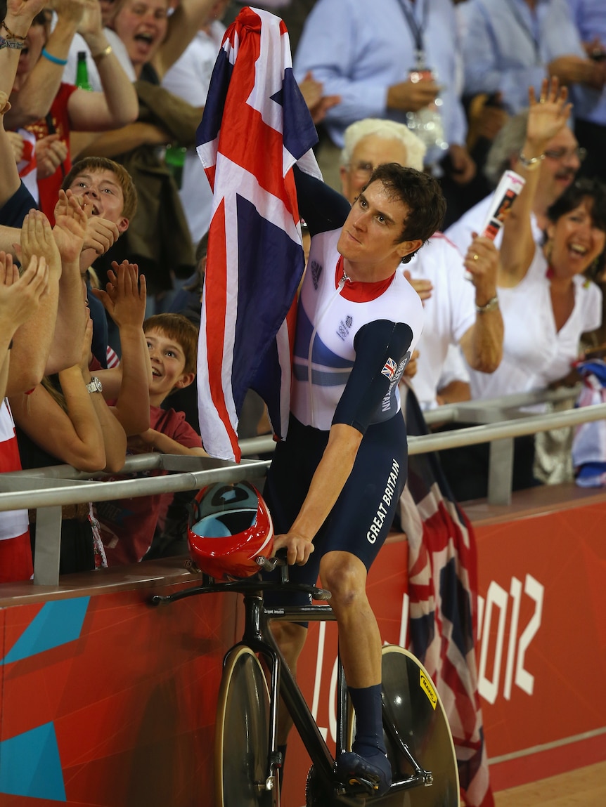Top of the world ... Geraint Thomas celebrates gold for Great Britain.