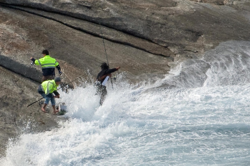 Huge wave washes onto fisherman on rocks at Salmon Holes