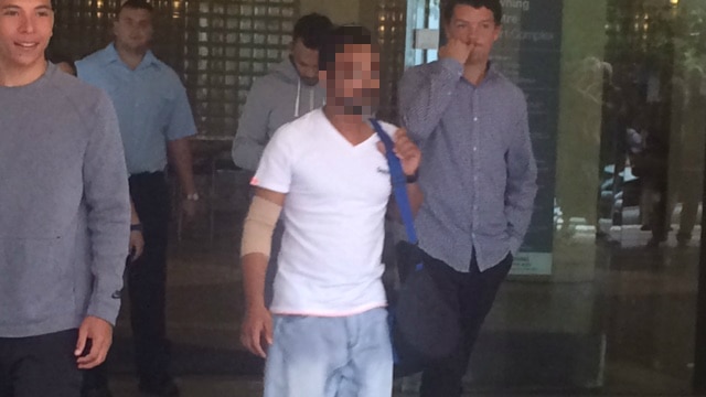 A man in jeans and a white shirt leaves court.