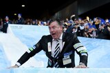Collingwood president Eddie McGuire takes part in Big Freeze ice slide at the MCG on June 13, 2016.