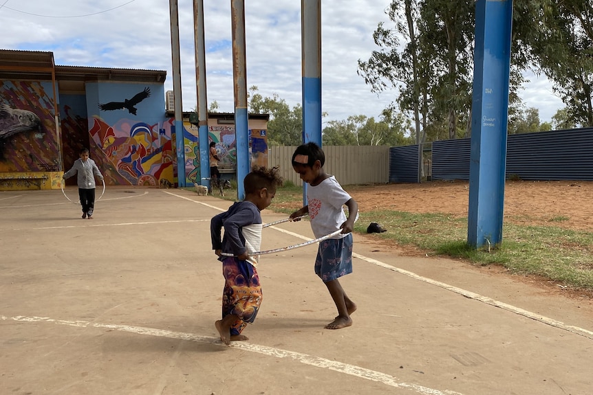 Two indigenous children playing together.