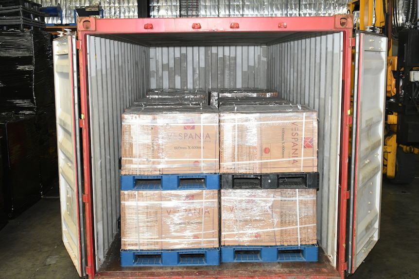 An open shipping container with boxes containing the drug heroin.
